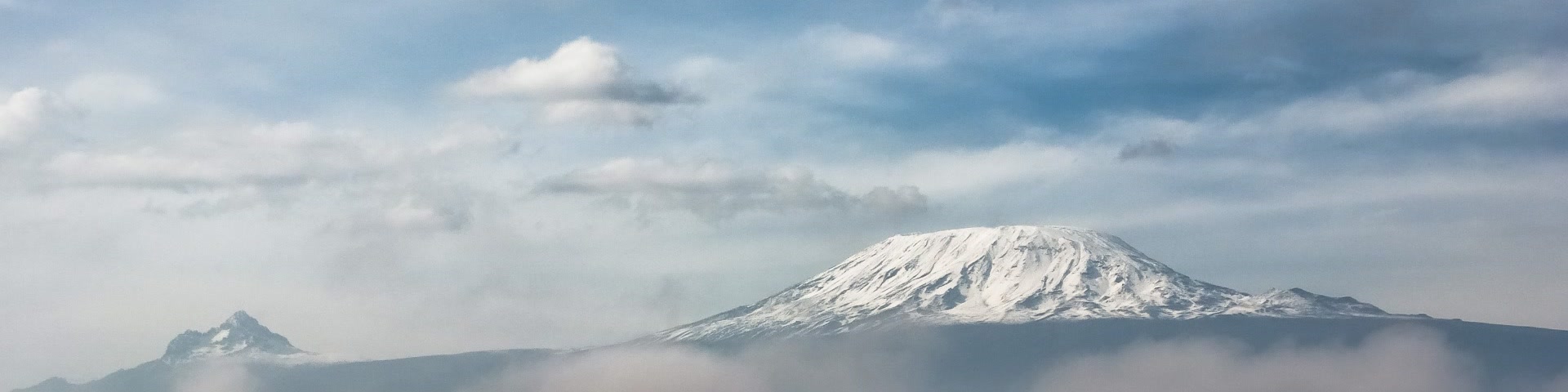 Mount Kilimanjaro's Kibo summit under snow, seen from the southern slopes above the treeline